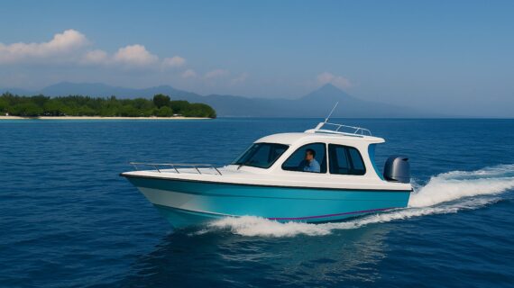 A private speed boat traveling across blue waters on the way to the Gili Islands, with green coastline in the background.